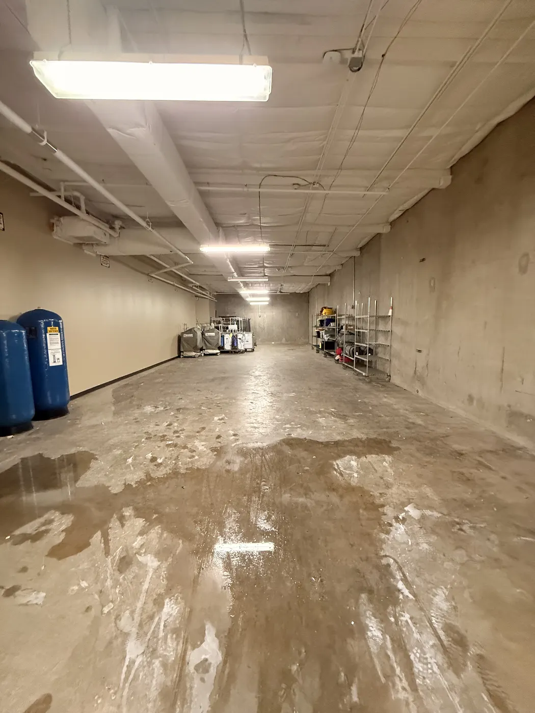 After cleanout: the same warehouse floor cleared, with only a small amount of equipment remaining.